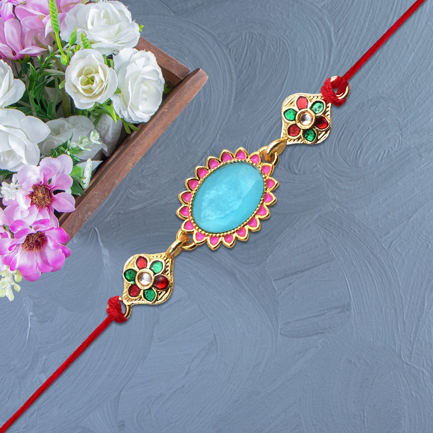 Blue Stone Rakhi With Floral Meenakari Accents Blue Stone Rakhi With Floral Meenakari Accents